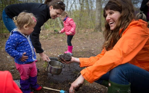 a person and a child planting seeds