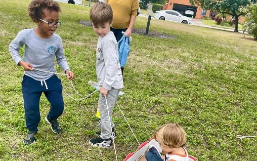 a group of people playing with a rope