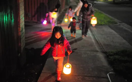 a girl holding a lantern