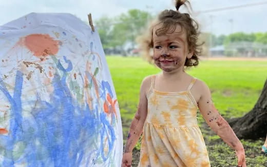 a girl holding a painting