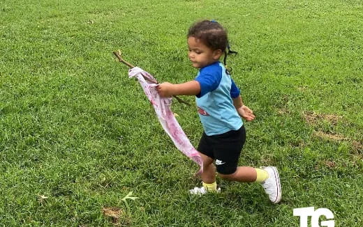 a girl running in a grassy area