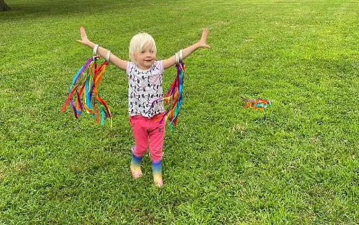 a little girl flying a kite