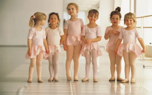 a group of girls in white dresses