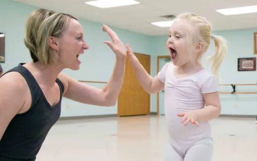 a woman and a girl dancing