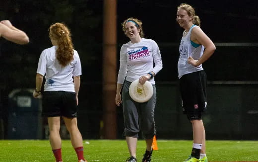 a group of women playing frisbee