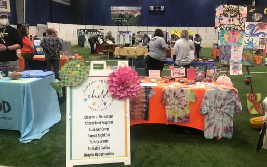 a group of people at a table with flowers and signs