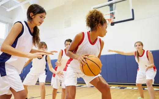 a group of women playing basketball