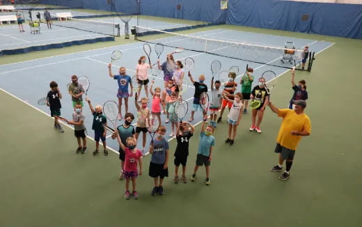 a group of people holding tennis rackets