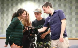 a group of people looking at a camera