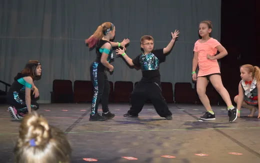 a group of children dancing on a stage