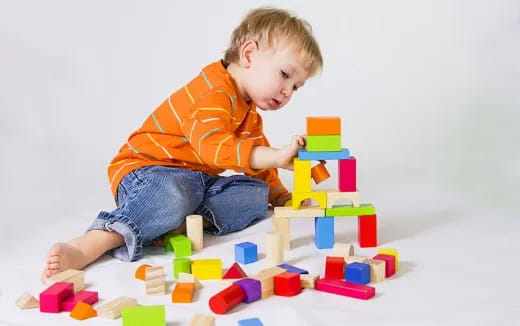 a baby playing with blocks