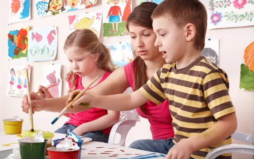 a group of children painting