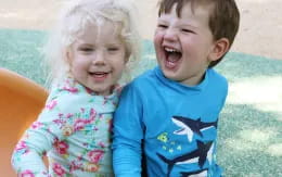 a couple of children laughing