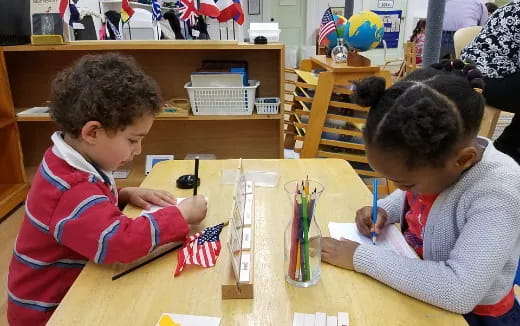 a few children sitting at a table