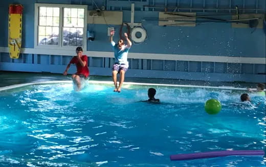 a group of people playing in a pool