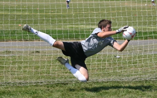 a person diving for a football ball