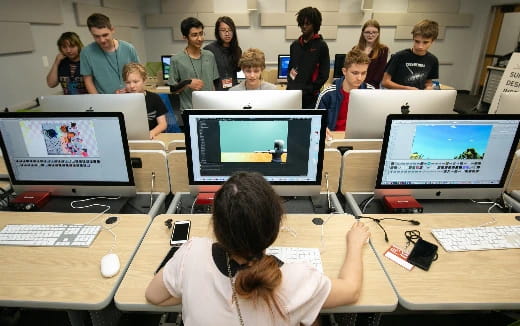 a group of people in a room with computers