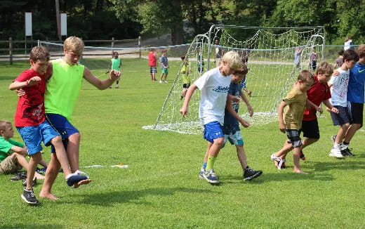 a group of kids playing football