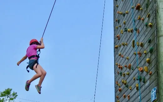 a girl climbing a rope