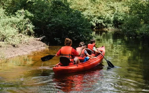 a group of people in a canoe on a river