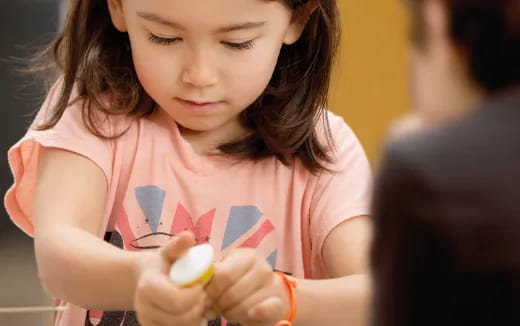 a girl holding a toy