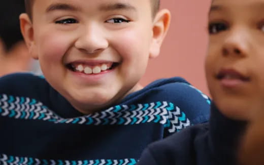 a close-up of a boy smiling