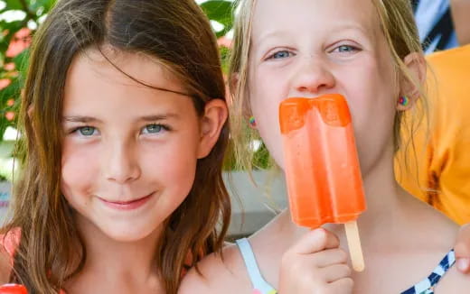 a couple of girls holding an ice cream cone