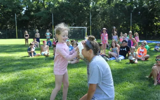 a girl and a boy playing in a park