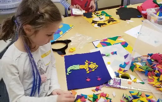 a young girl coloring on a paper