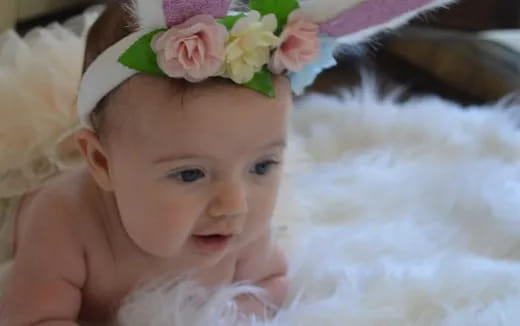 a baby with a flower crown