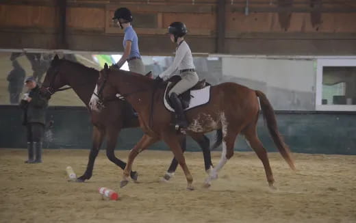 a couple of people riding horses