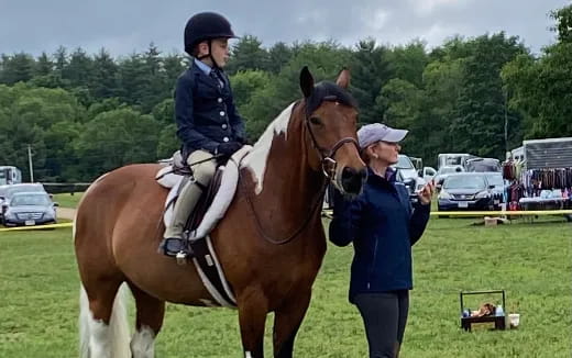 a person standing next to a horse