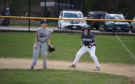 a couple of baseball players on a field