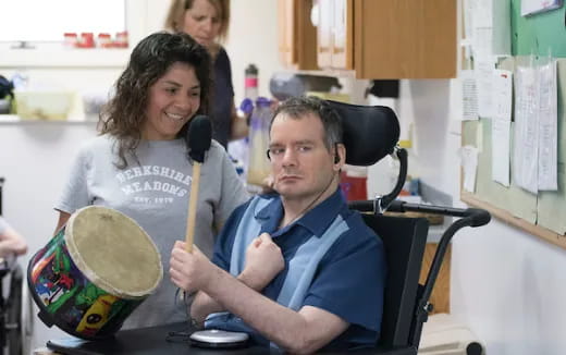 a man and a woman holding drums