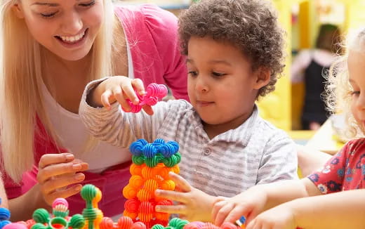 a person and a child playing with toys