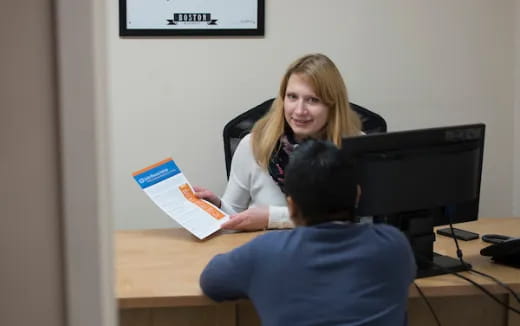 a woman holding a piece of paper