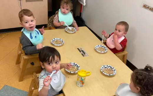 a group of children eating at a table