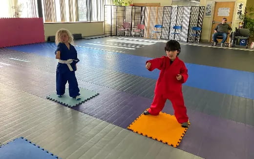 a couple children playing on a mat