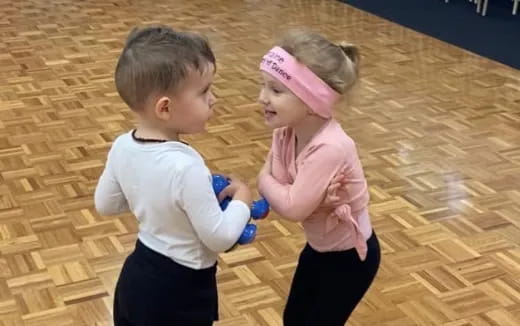 a boy and girl playing with toys