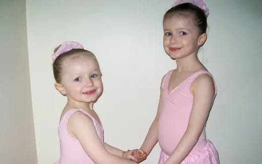 a couple of girls posing for the camera