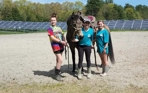 a group of women with a horse