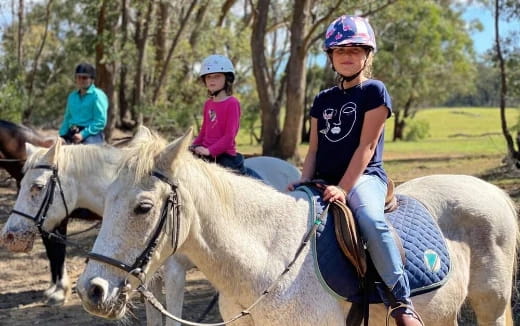 a group of people riding horses