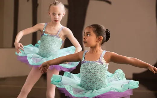 two girls dancing on a stage