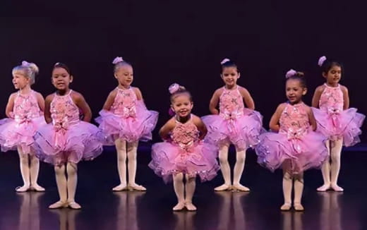 a group of girls in dresses