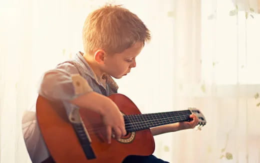 a boy playing a guitar