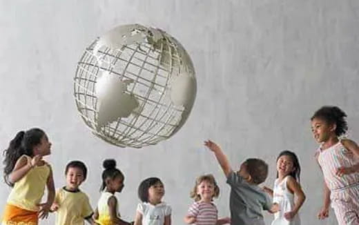 a group of children looking at a large globe