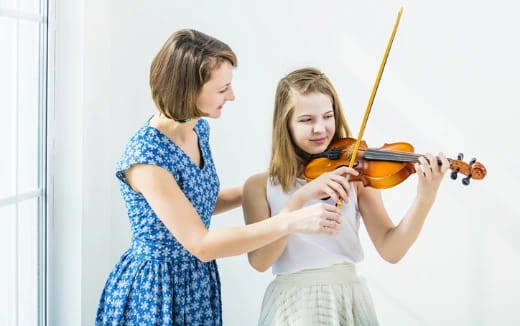 a person and a girl playing violin