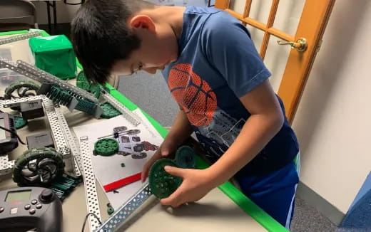 a young boy working on a circuit board