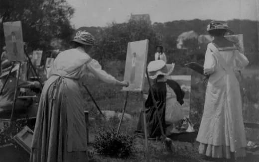 a group of women carrying boxes