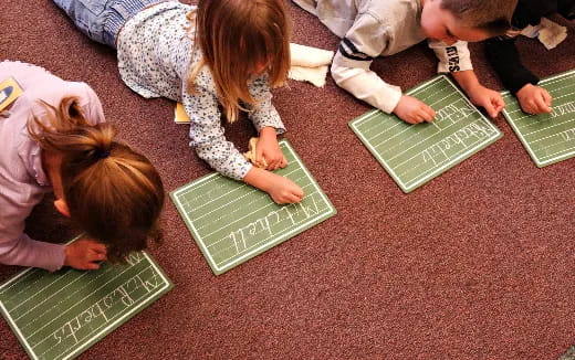 children playing with green laptops